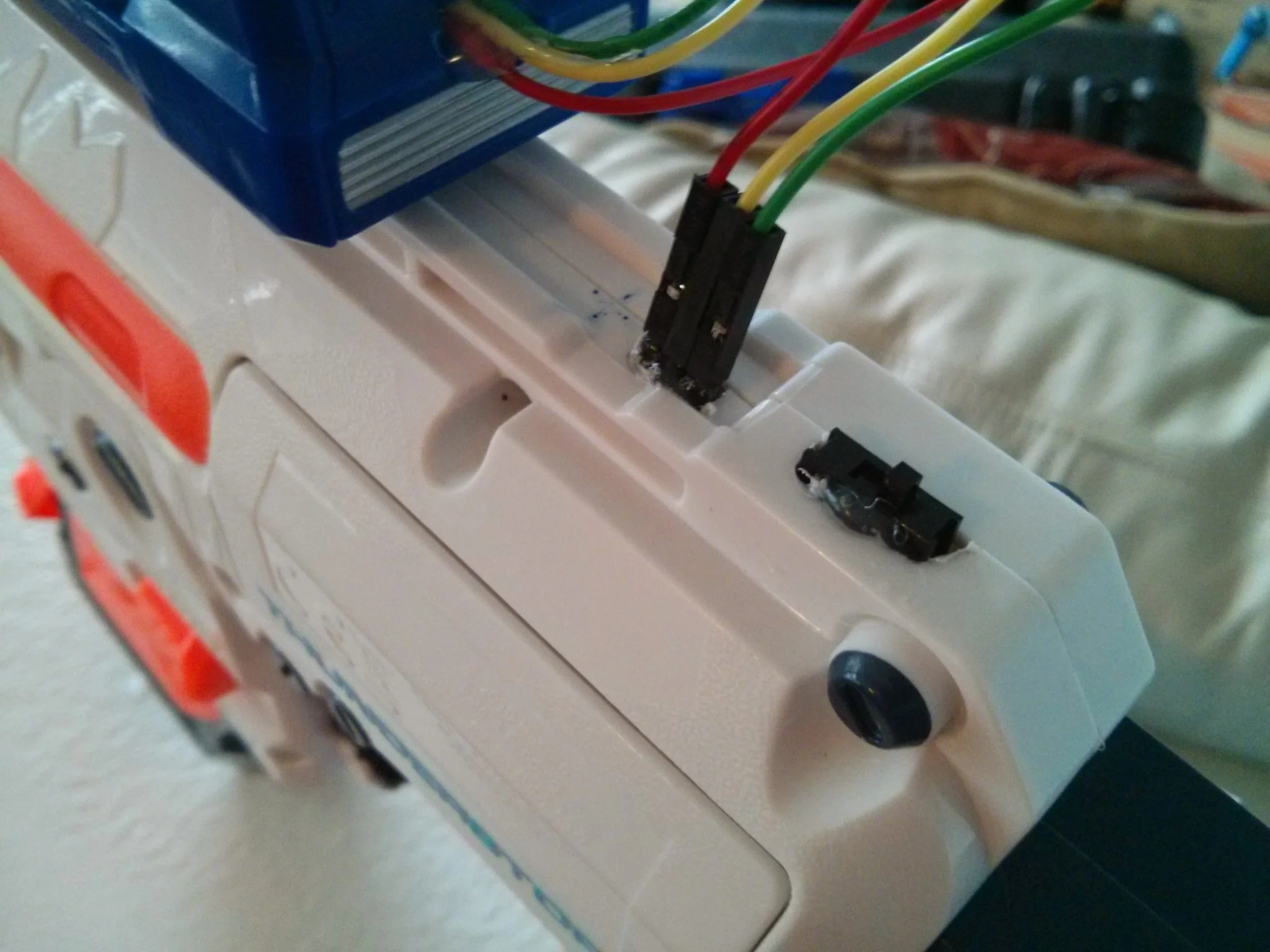 Pins that allow you to control firing of the gun and a switch to turn Aux control on/off